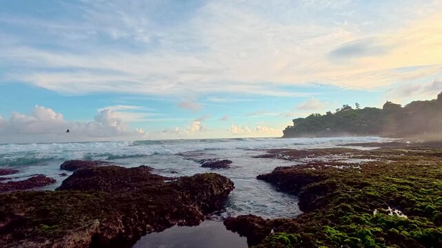 Wide rocky tidal pools under dramatic coastal sky
