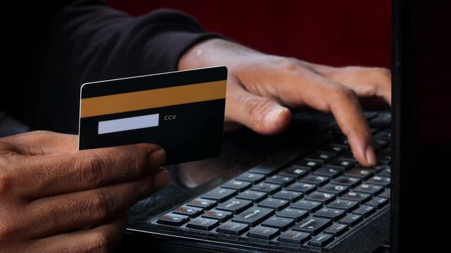 Credit Cards Theft. Hacker with Credit Cards on His Laptop Using Them For Unauthorized Shopping. Unauthorized Payments. Stolen Credit Cards Concept.