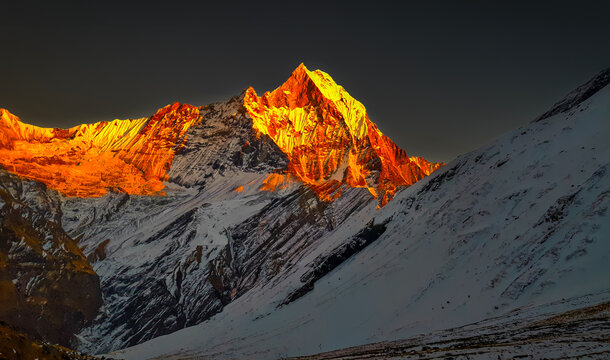 Golden Sunset in The Snow Mountain Peak.