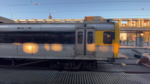 Commuter train at Lisbon metro station during sunset - Urban transport and travel concept