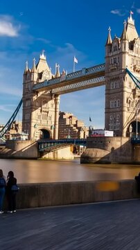 Tower Bridge in London, UK, United Kingdom. Time lapse. People walking. Vertical video