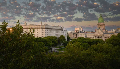 Fototapeten Buenos Aires Golden clouds drift above Buenos Aires beneath soft dawn morning light  © Tom