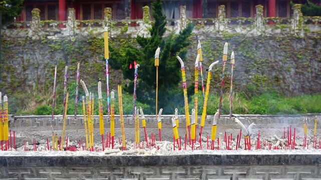 Smoking incense sticks burning in a censer for prayer at Tianmen Mountain in Zhangjiajie