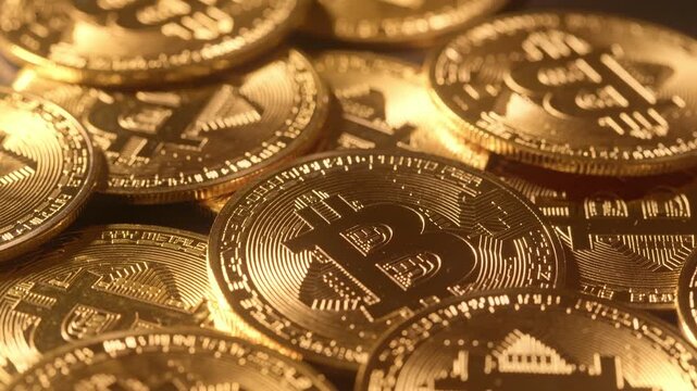 Several Bitcoin coins rotating together in close-up. Repetitive motion and reflective surfaces emphasize abundance, market flow and scalability in cryptocurrency ecosystems.
