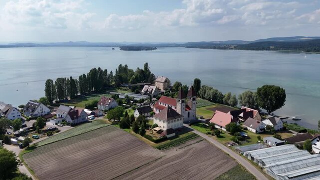 Panorama flight over church Basilica of Sts. Peter and Paul on island Reichenau towards Lake Constance (Bodensee) near Konstanz, Germany