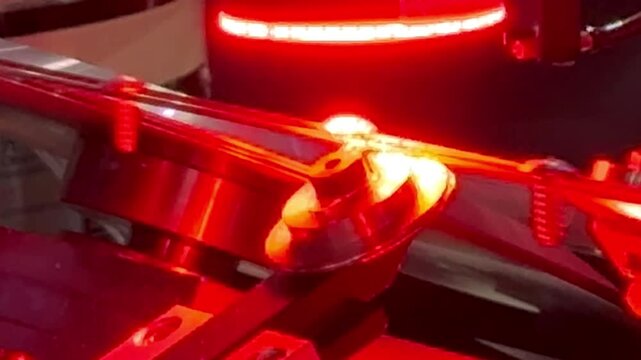 Automated machine vision inspection system checking screw quality with red LED light in factory