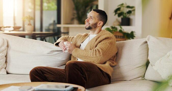 Happy man, relax and daydream with coffee in lounge, chill and comfortable on weekend or reflection. Thinking, person and smile with good memory, nostalgia and thoughtful with caffeine drink in house