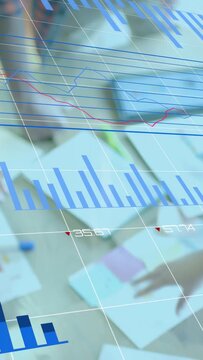 Vertical video: Team tapping tablet, pointing at papers causing HUD charts updating for analytics