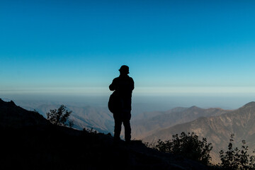Fototapeta premium Silhouette of traveler overlooking Andean mountains in Peru