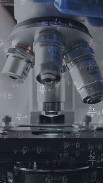 Vertical video: Lab tech hand touching turret, rotating lens over stage, math overlay guiding focus