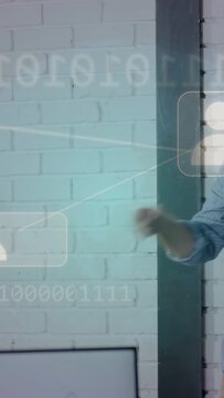 Vertical video: Man holding tablet, peer pointing, tech overlays showing, man evaluating results