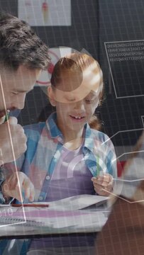 Vertical video: Male teacher leaning, pointing to workbook, girl writing while HUD aiding education