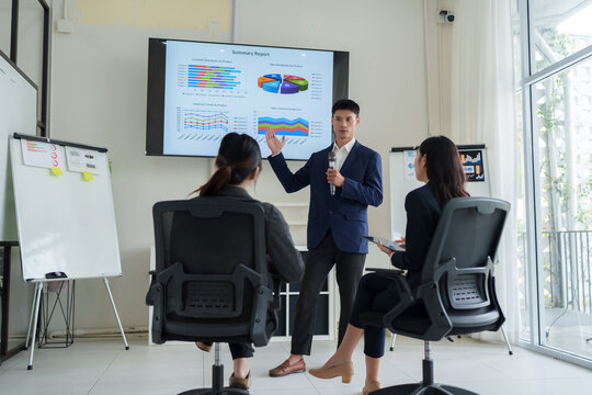 Business team presenting data analysis during corporate meeting
