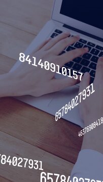 Vertical video: Woman typing on laptop keyboard initiating numeric overlay over keys for tech
