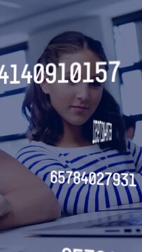 Vertical video: Student sitting desk while numbers moving, clearing as peer typing laptop for class