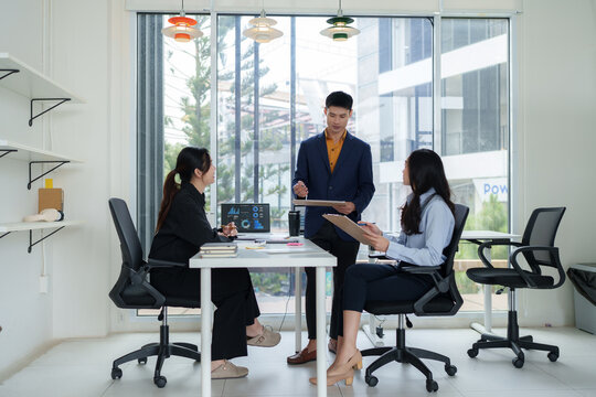 Business team collaborating on data analytics in modern office