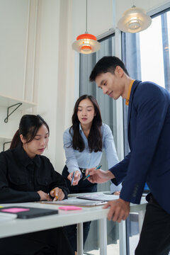 Business team collaborating, discussing project ideas in office