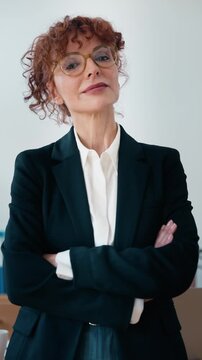 Video of elegant business woman looking at camera in the office