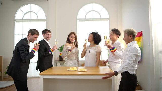 Happy LGBTQ friends raising champagne glasses together during a Pride Month celebration party at home