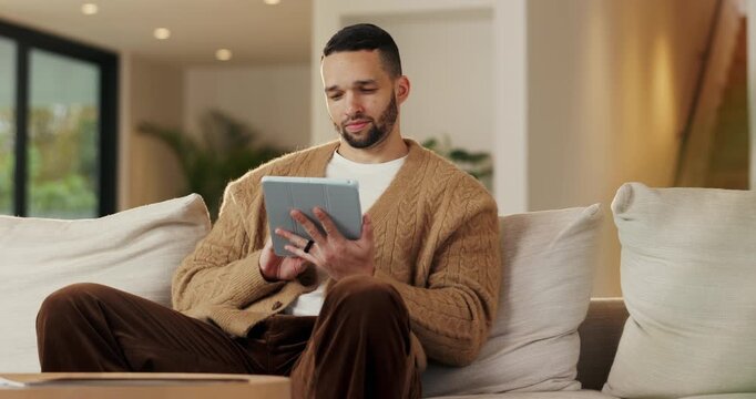 Remote work, review or copywriter on couch with tablet, proofreading or email feedback for blog draft. Reading, wfh or man in house with tech, fact check or script planning with industry research.