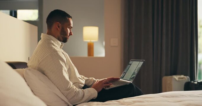 Business trip, laptop and remote work with man in hotel room for planning or research. Computer, scrolling and typing with corporate employee on bed in lodge for accommodation or hospitality