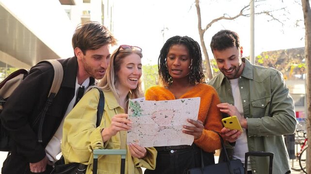 A close-knit group of friends is gathered around a map, engaged in lively discussion while checking a smartphone for navigation. Their excitement for exploration is clearly evident in their