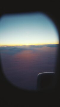 Traveling by plane and looking at porthole, admiring sunset above horizon. Unique experience of travel by modern airlines, business trip or summer vacation trip, night flight, air transport safety