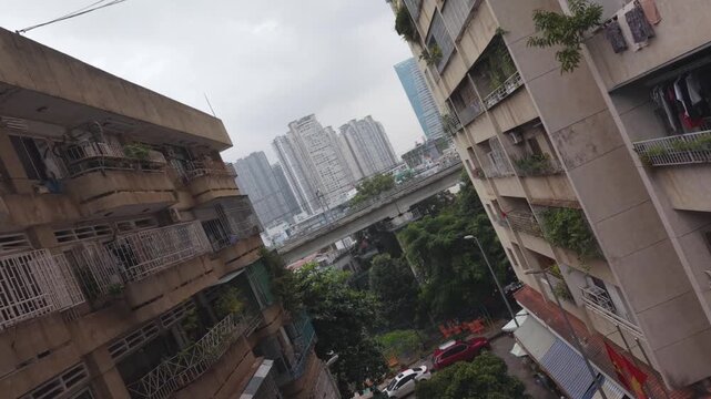 Dynamic drone fly through between apartment buildings as Metro Train passes in Ho Chi Minh City