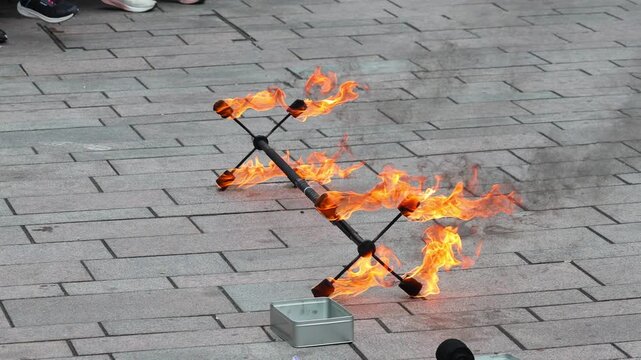 A circus performer performs a fire dance. Fire show.