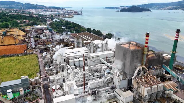 Aerial view of a pulp and paper mill releasing steam