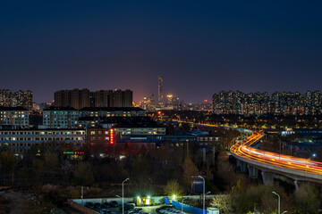 Fototapeta premium China Blues Moment: Commuter traffic at Jiugong Station on Beijing's Yizhuang Line; Distant view of the CBD and the skyline of China Zun.