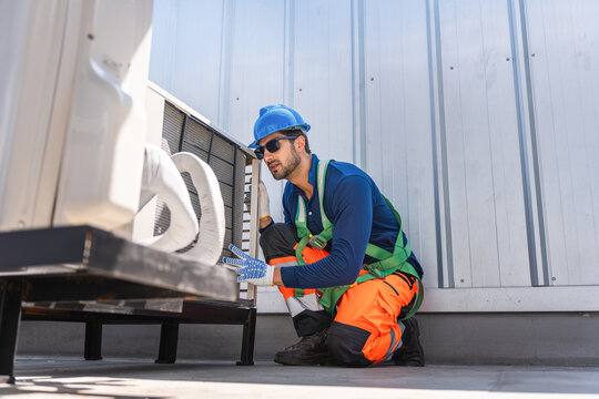 HVAC technician measuring refrigerant pressure in air conditioning system, Air conditioner maintenance, technician service checking outdoor refrigerant levels air conditioner unit in factory or home