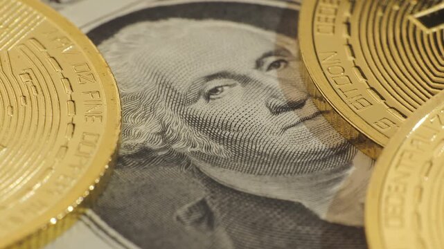 Closeup of bitcoin coins covering dollar banknote portrait background, cryptocurrency finance concept showing digital payment and investment economy