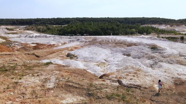 Woman photographer captures kaolin quarry in Ukraine from an aerial view with an open pit and porcelain clay production