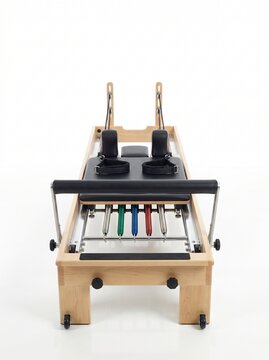 Modern Wooden Pilates Reformer Machine for Enhanced Core Strength and Full-Body Fitness Training on White Background