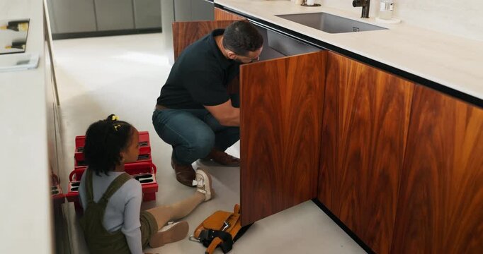 Repair, tools and dad with child in kitchen for maintenance, plumbing issue and diy by sink. Family, home and father with girl for help, learning and bonding with equipment for leak, pipes and fixing