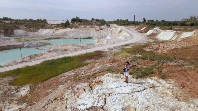 Woman photographer captures kaolin quarry in Ukraine from an aerial view with an open pit and porcelain clay production