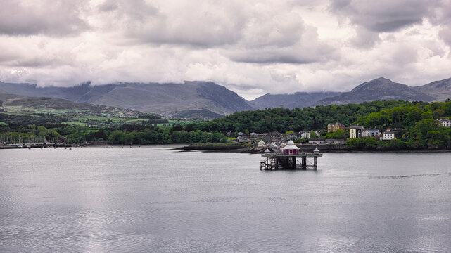 Looking across the Menai Staright towards Bangor pier. The cloud topped mountains are in the background