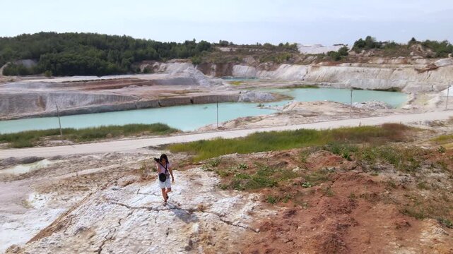 Woman photographer captures kaolin quarry in Ukraine from an aerial view with an open pit and porcelain clay production