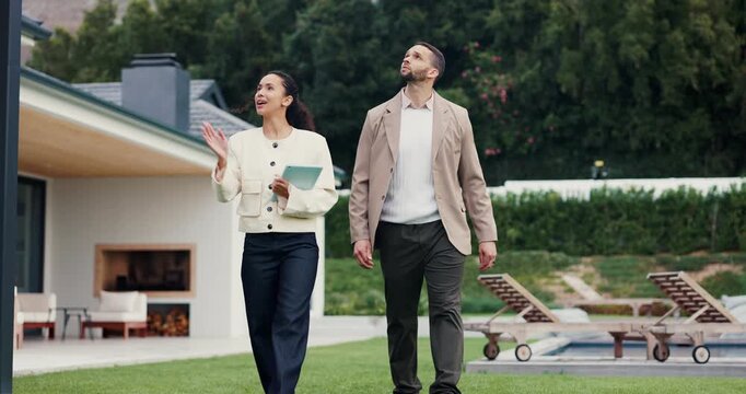 Woman, realtor and tour with customer for property investment, sale or inspection in backyard. Female person, real estate agent or walking with client on lawn for home viewing or house accommodation