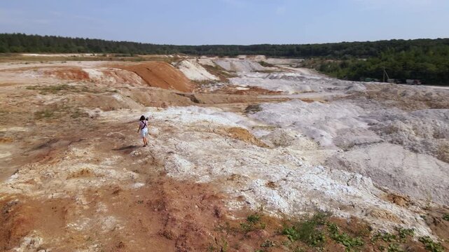 Woman photographer captures kaolin quarry in Ukraine from an aerial view with an open pit and porcelain clay production