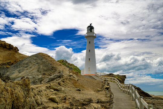 Castlepoint lighthouse standing on rocky new zealand coastline
