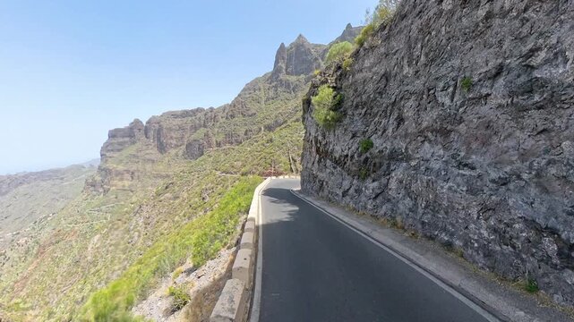 Driving on mountain serpentine road TF-436 in Masca Valley, Tenerife, Canary Islands, sunny scenic route with lens flare, shot on 360 camera 