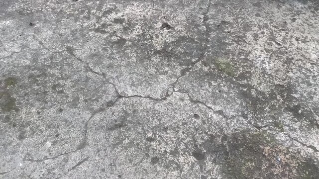 Grungy weathered concrete surface texture with white stains and cracks