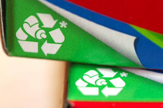 Close-up of a recycling symbol printed on toothpaste packaging.