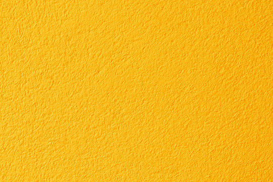 Yellow color concrete wall texture for background and design.