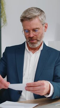 Mature business man open envelope letter, reading it. Career growth advance promotion, bank loan approve, successful admission to monetary award, long-awaited invitation, great news, lottery game win