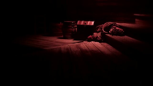 Pirate chest, kegs, and ropes sit under lantern light. Wharf or ship's hold.