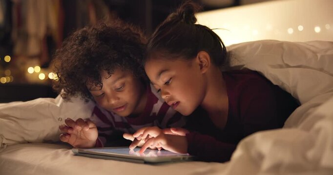 Siblings, night and children in bedroom on tablet for online entertainment, educational games and internet. Family home, happy and kids on digital tech for connection, relax and story app at bedtime