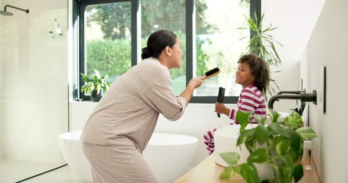Mother, child and singing with hairbrush in bathroom for grooming, fun morning routine and bonding. Happy, mom and son with haircare tool in home for karaoke, getting ready and dancing with self care